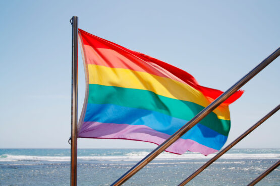 C1YFGC Rainbow flag outside bar on Maspalomas beach on Gran Canaria, Canary Islands
